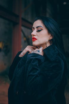 一位妆容鲜明、红唇、身着深色夹克的女性侧面肖像