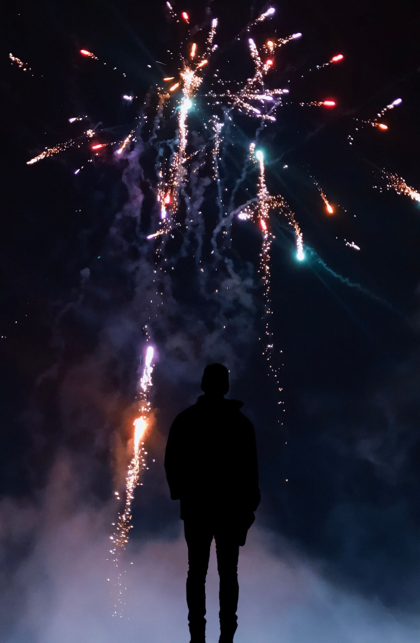 Silhouette of Person in Front of Fireworks · Free Stock Photo