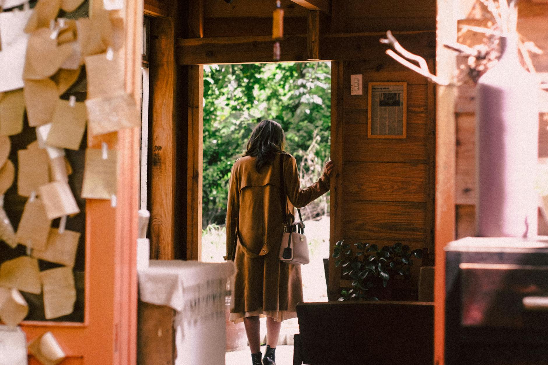 ADHD doorway effect adhd & emotions adhd — person standing confused in kitchen doorway warm afternoon light