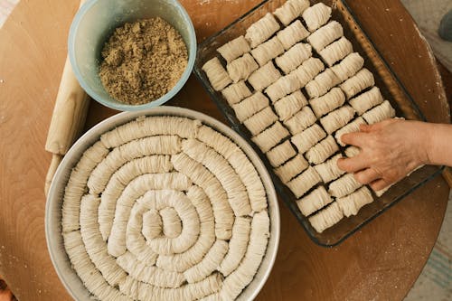 Hand over Tray and Bowls with Rolled Dough