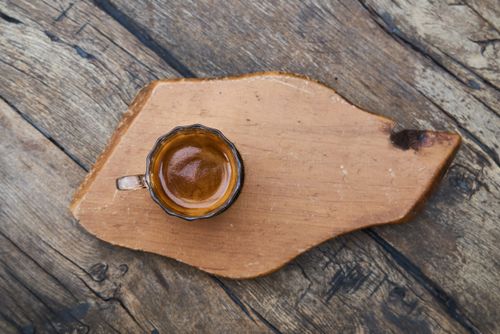 Free A top-down shot of an espresso coffee cup on a rustic wooden board, creating a warm and earthy feel. Stock Photo