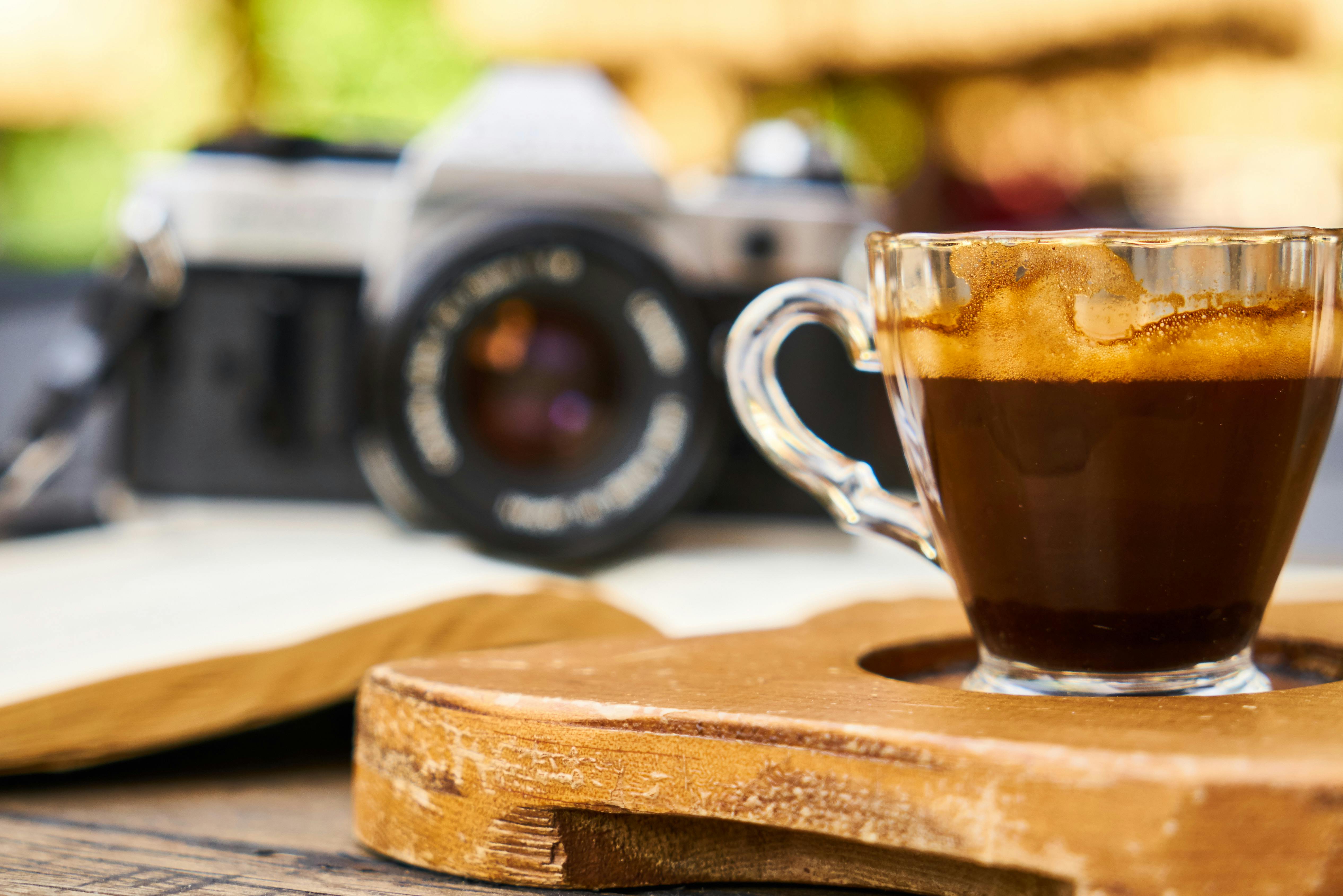 glass teacup on brown wooden coaster