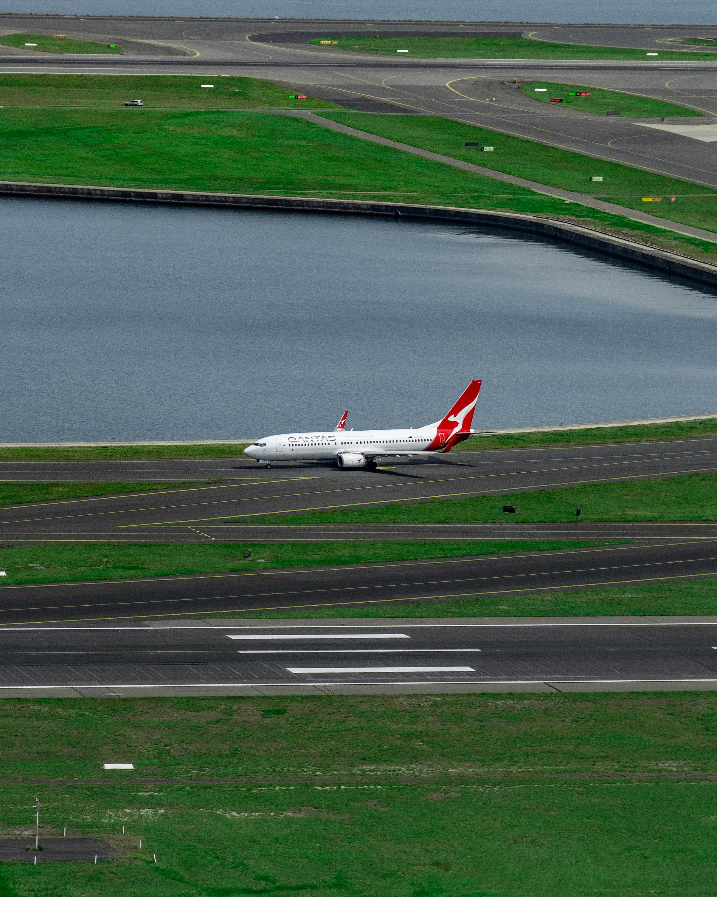 white and red airplane on runway