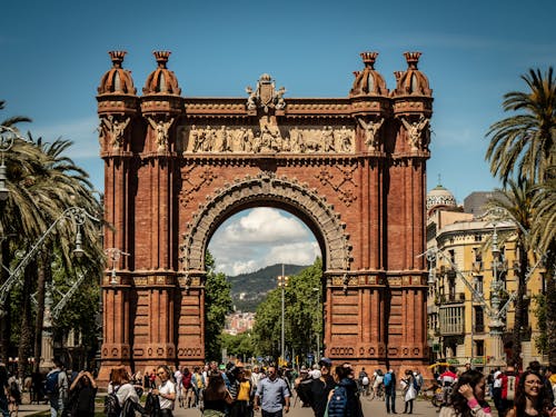 People Standing Near Brown Arched Gate