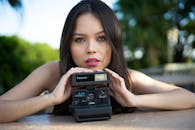 Portrait of Woman Holding Gray Polaroid Camera