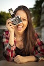 Portrait of Woman Holding Gray and Black Dslr Camera