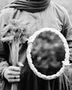 A woman holding a mirror with flowers in it