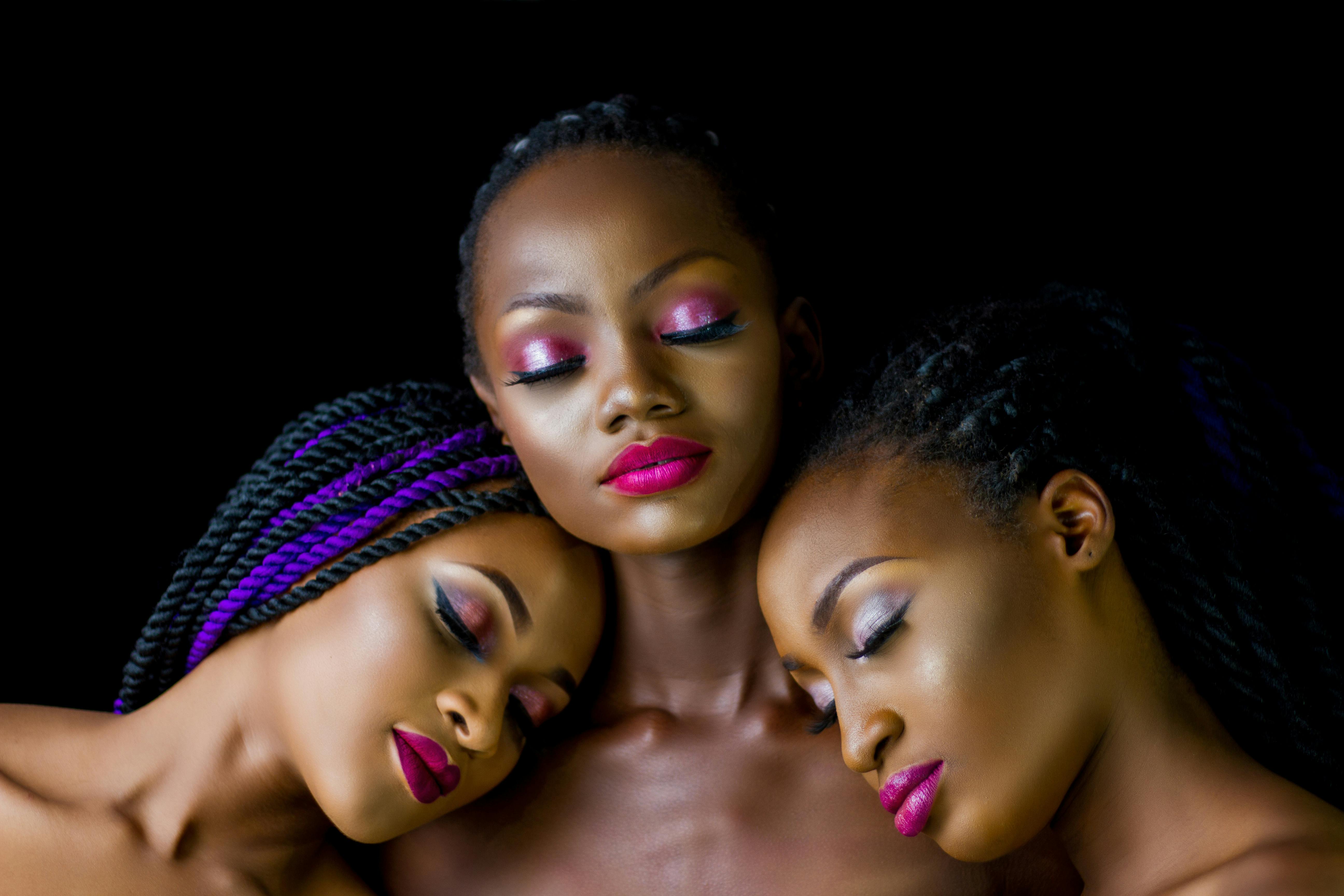 two women lying their heads on woman s shoulder