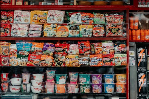 A shelf full of different types of noodles