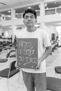 Young man holding a religious sign inside a church in Mexico City.