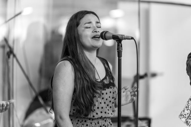 Black and white photograph of a singer mid-performance. Photo by Israel Torres on Pexels