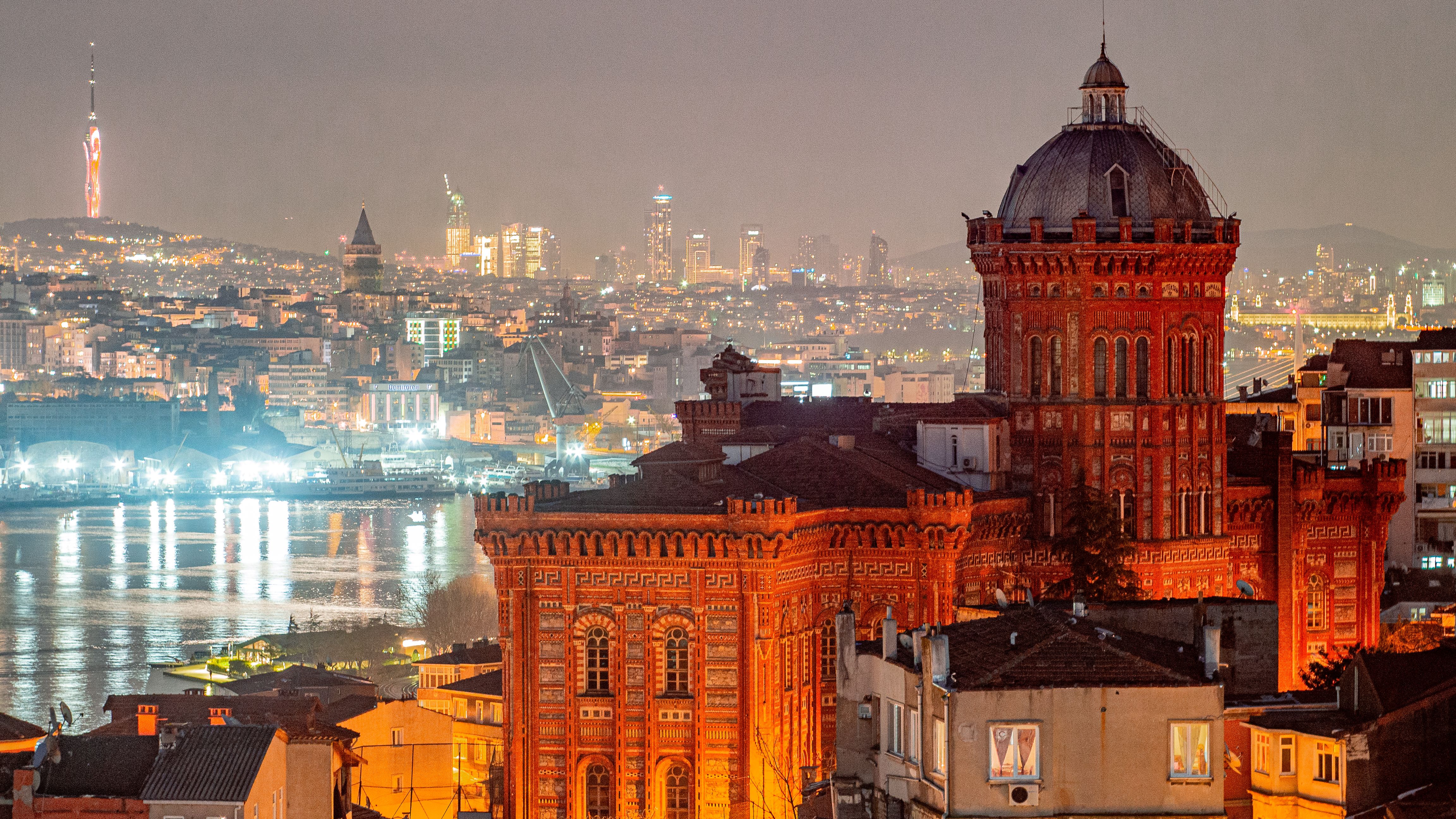 Fener and Balat. Stunning cityscape of Istanbul featuring the illuminated Red School and city skyline at night.