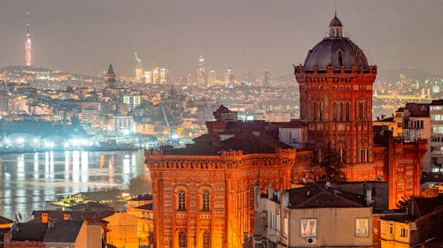 A city skyline with buildings and lights at night