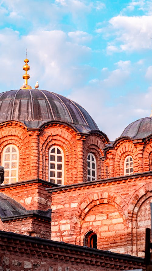 The domes of a church are shown against a blue sky