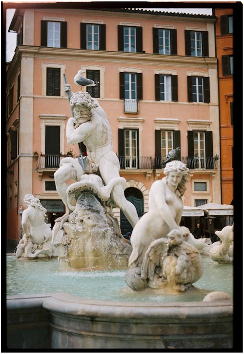 A fountain with statues in front of it