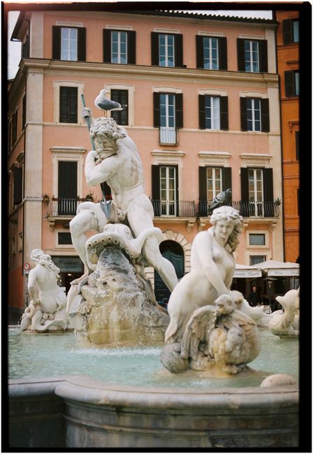 Iconic Fountain of Neptune in Piazza Navona, Rome, surrounded by historic architecture.