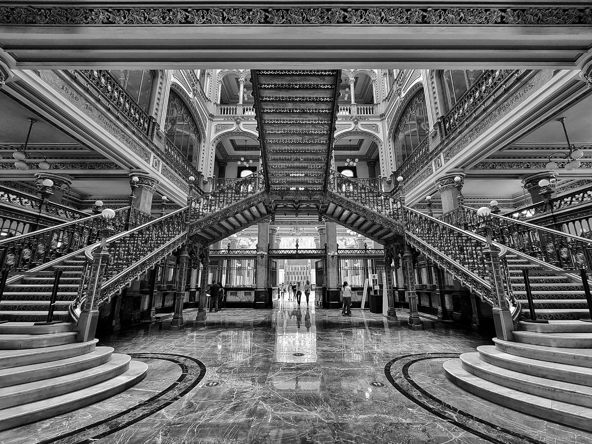 Elegant black and white capture of the iconic staircase at Palacio de Correos de México.