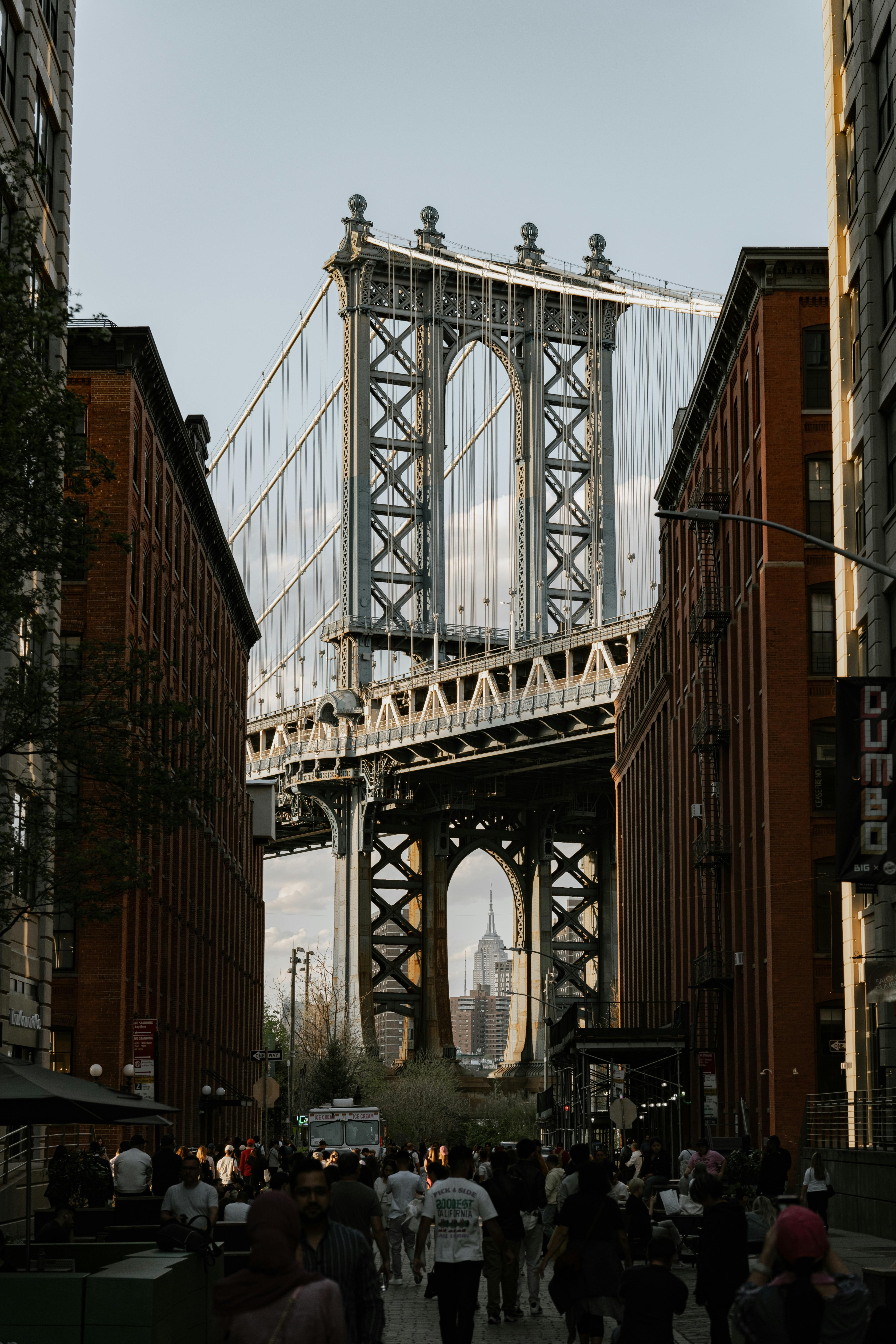 Stunning view of the Manhattan Bridge framed by Brooklyn buildings with the Empire State Building in the background.