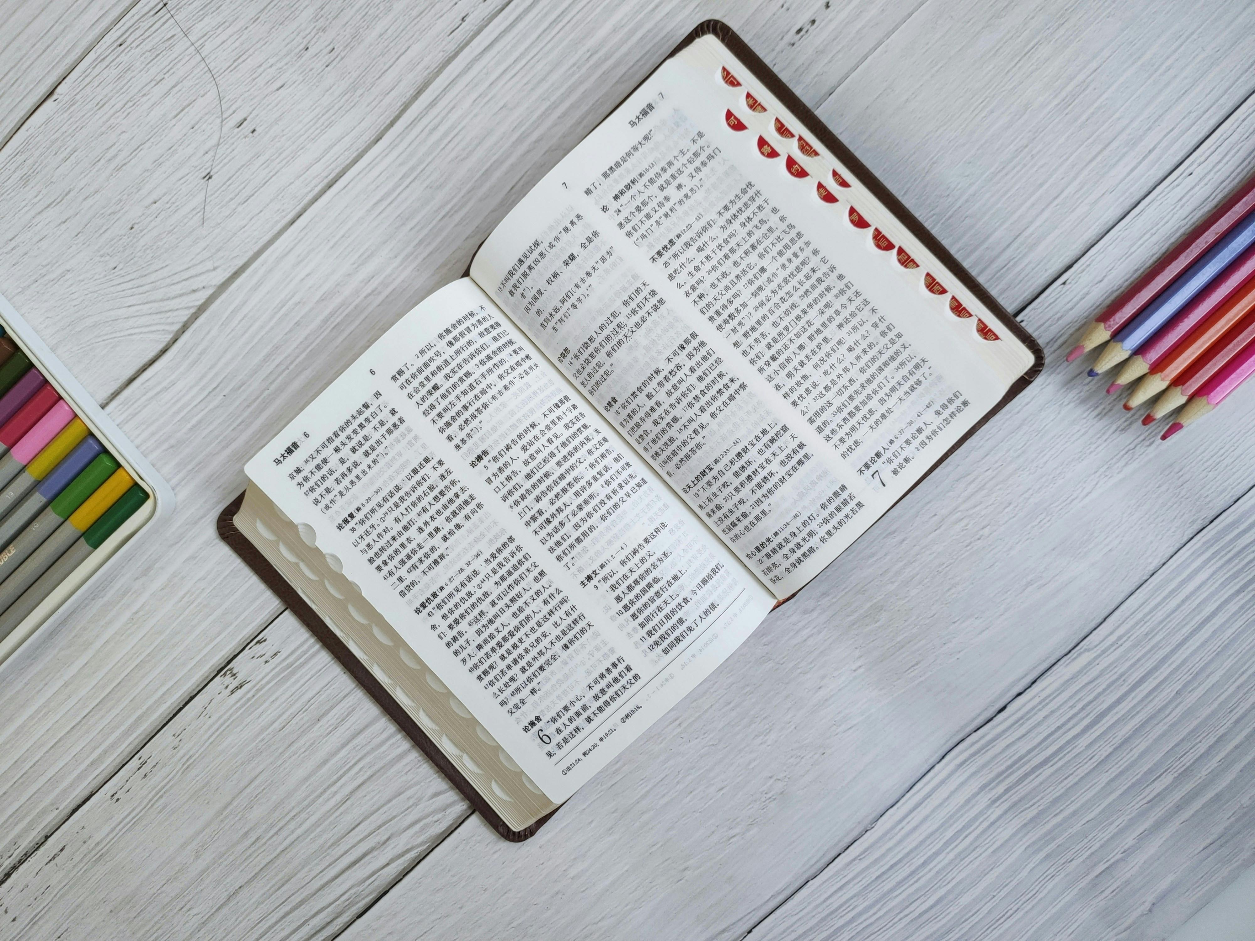 bible in chinese on table by crayons