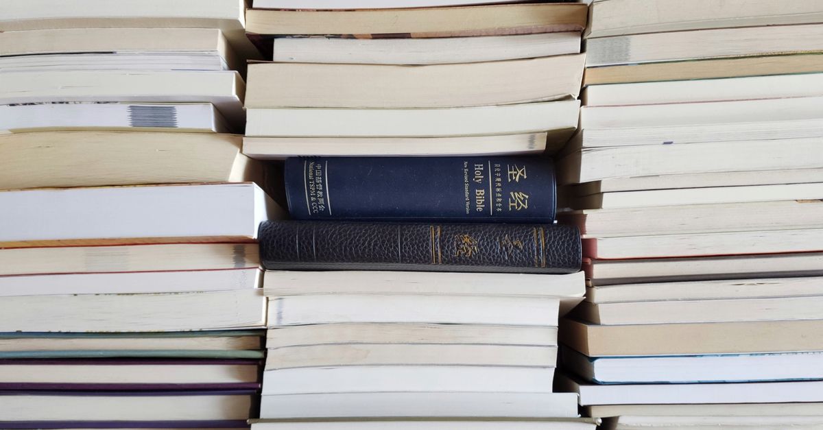 Paperback books stacked on a desk for a reading giveaway