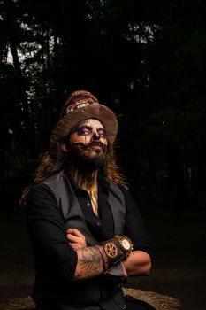 Man in steampunk clothing with makeup in a park, expressing unique style.