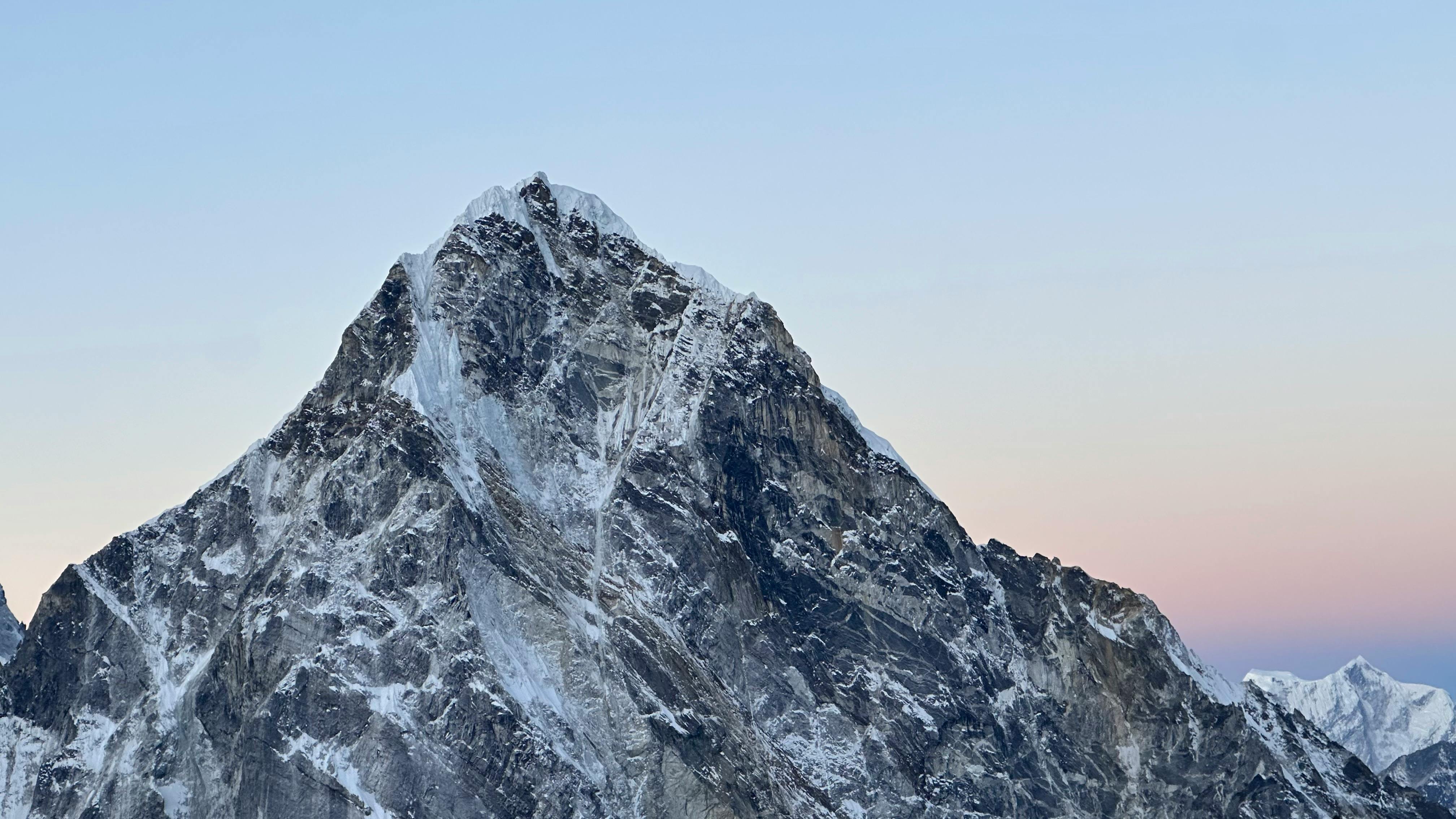 Snow-capped peak in the Himalayas, Nepal, captured during a serene sunset.