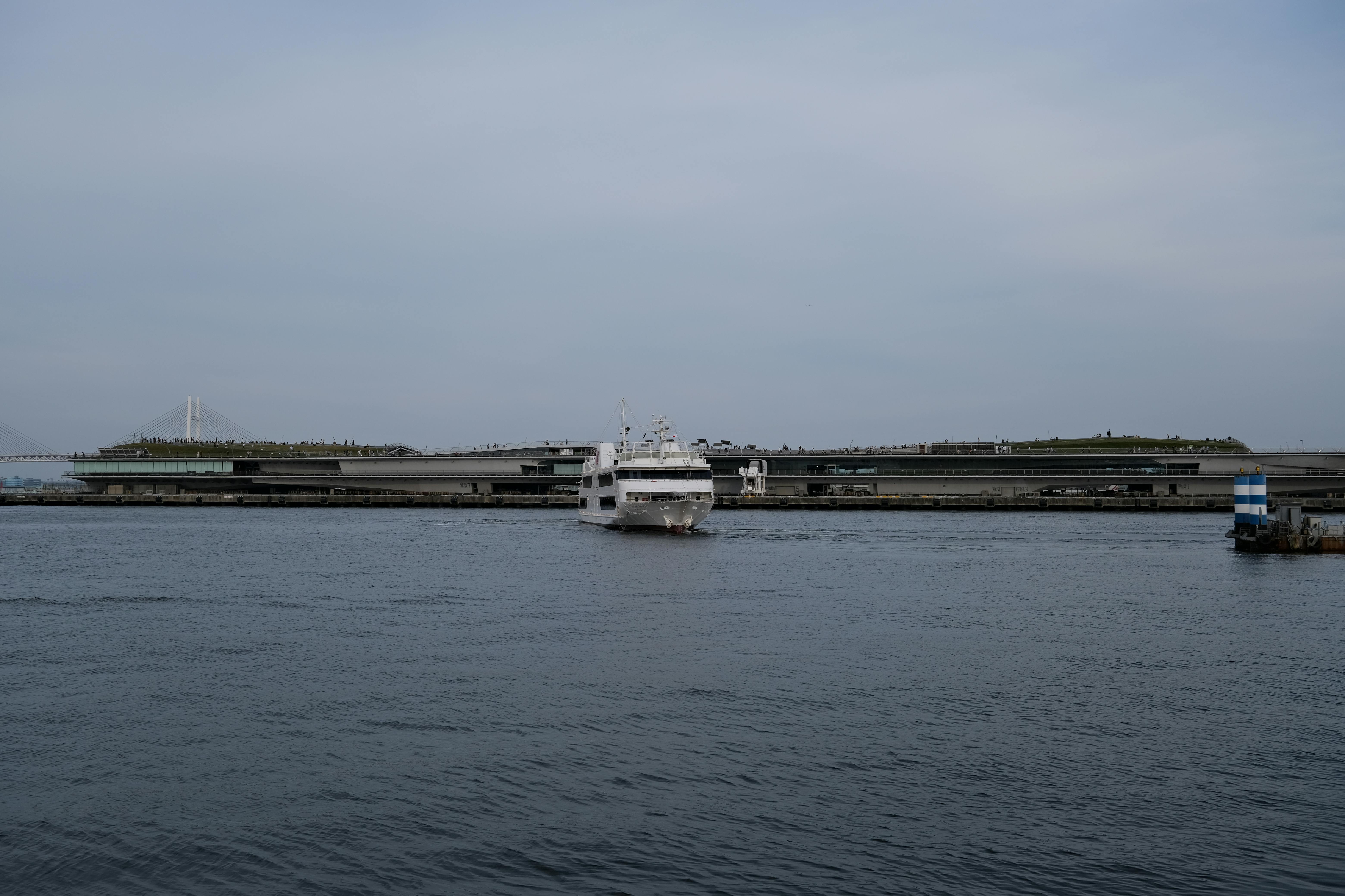 A serene view of a cruise ship approaching Yokohama harbor, Japan.