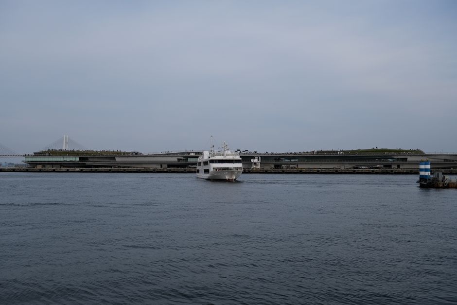 A serene view of a cruise ship approaching Yokohama harbor, Japan.