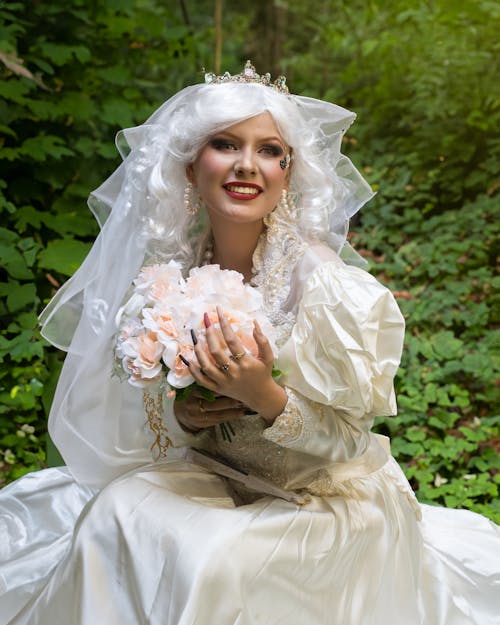 A woman in a wedding dress holding a bouquet