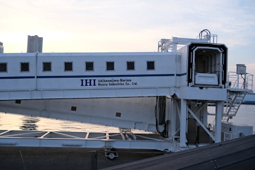 A white and blue boat with a ramp on the side