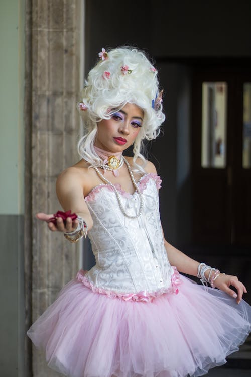 A woman in a white tutu and pink dress