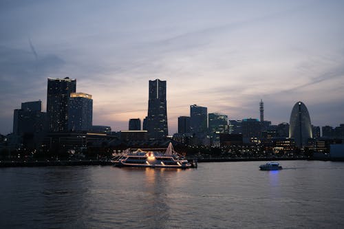 A boat is docked in front of a city skyline