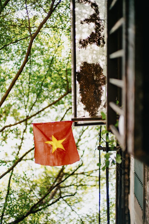 A vietnamese flag hanging from a window
