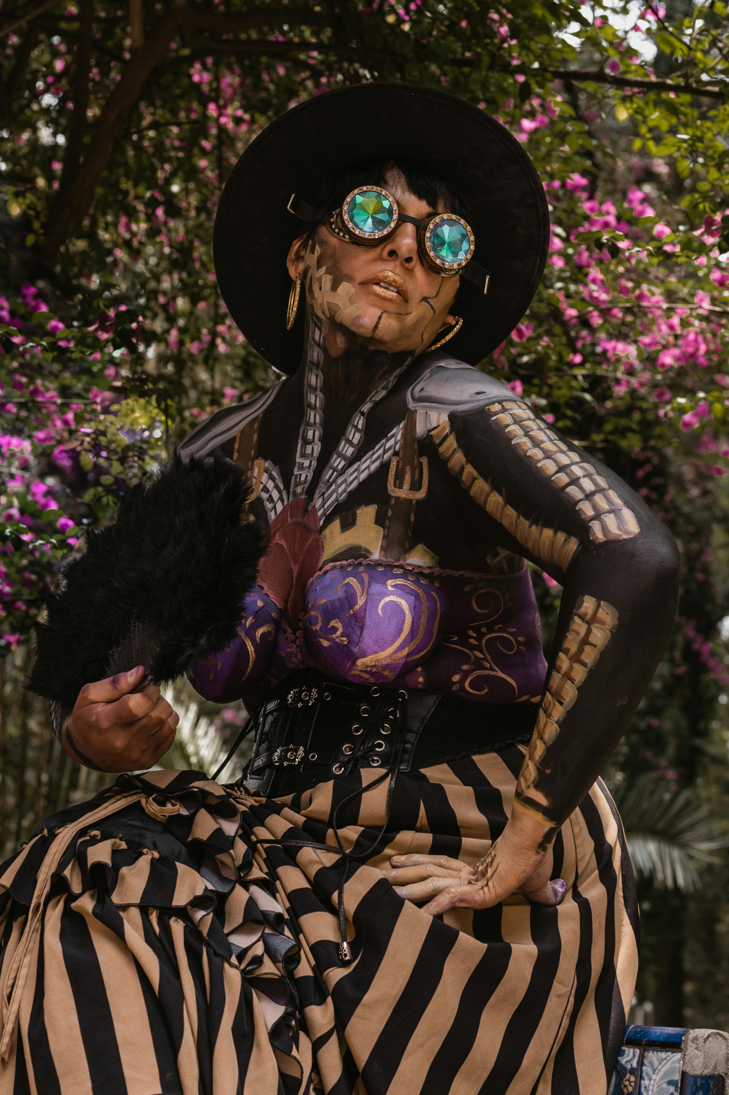 A unique steampunk fashion portrait of a woman with goggles and vibrant outfit, set outdoors.