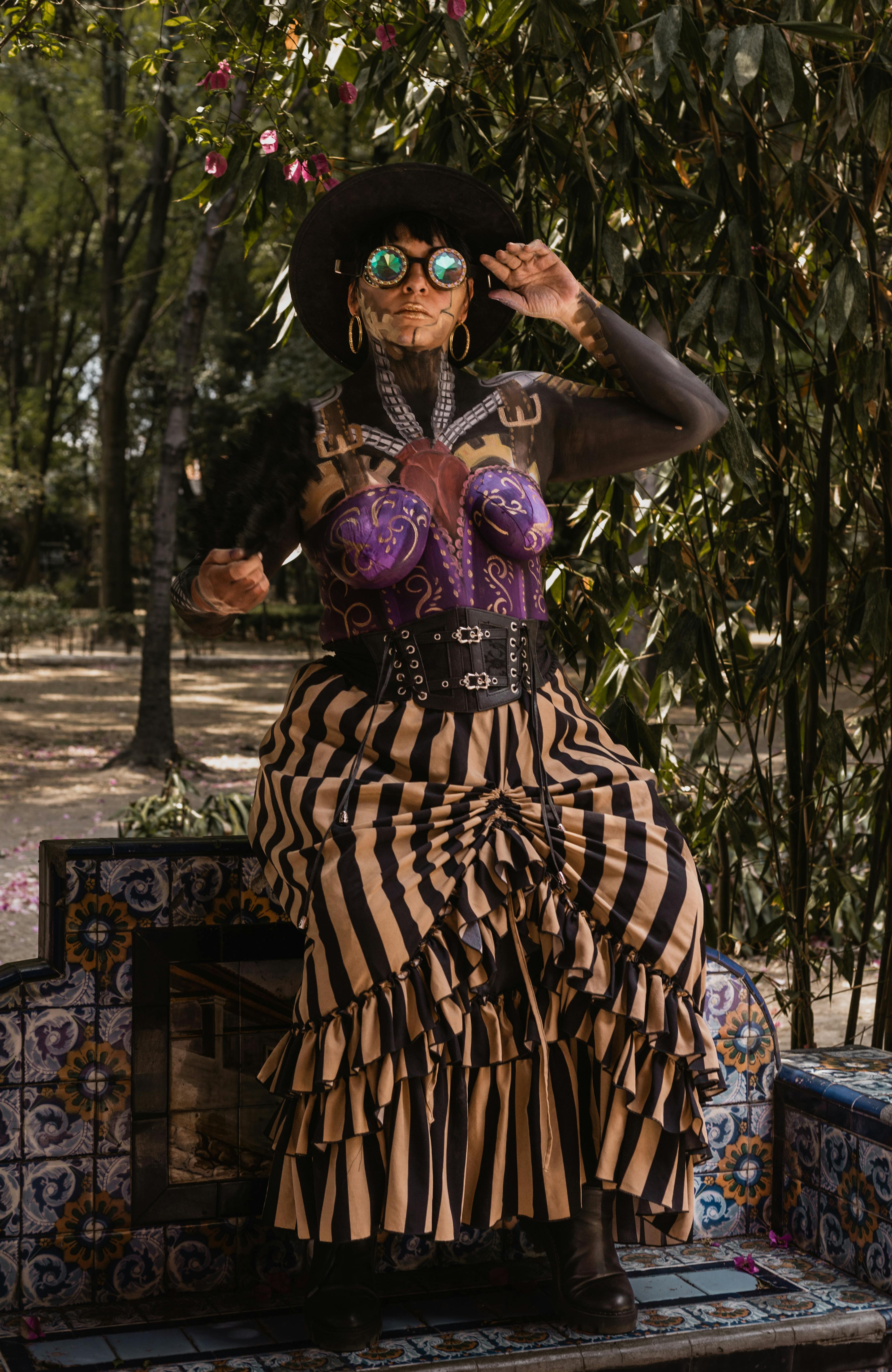 Steampunk-inspired body painting with costume in a vibrant outdoor park setting.