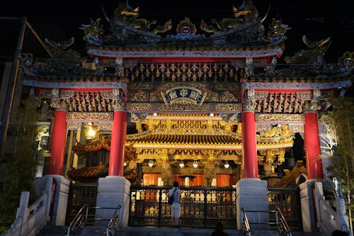 A large asian temple with red and gold decorations