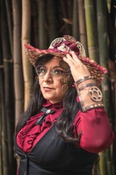 Elegant steampunk portrait of a woman with unique accessories in a bamboo setting, CDMX.
