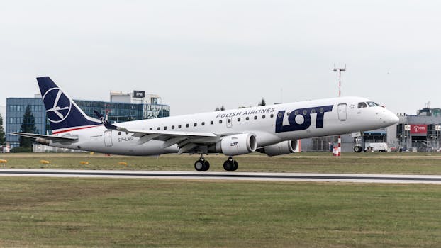 LOT Polish Airlines aircraft on tarmac at Prague airport, preparing for takeoff.