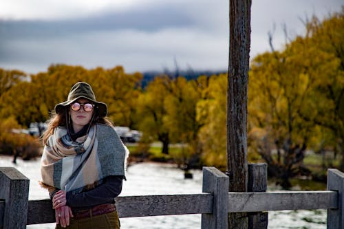 Free Woman Leaning Against Wooden Fence Stock Photo