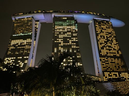 Free Iconic Marina Bay Sands hotel in Singapore beautifully lit against the night sky. Stock Photo