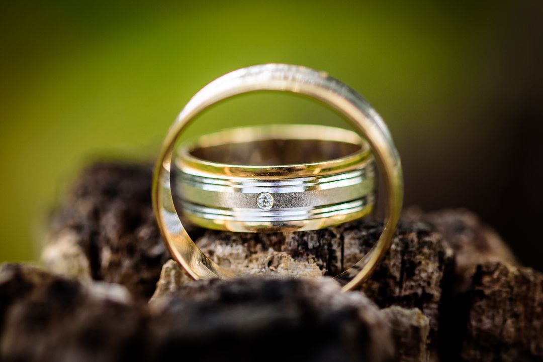 does the wedding band go on top or bottom — two-tone wedding bands stacked on rustic wood — FoundryCut