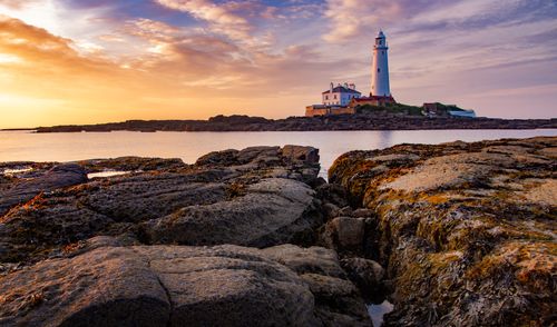Free Capture of St Mary's Lighthouse in Whitley Bay during a vibrant sunset, creating a picturesque scene. Stock Photo