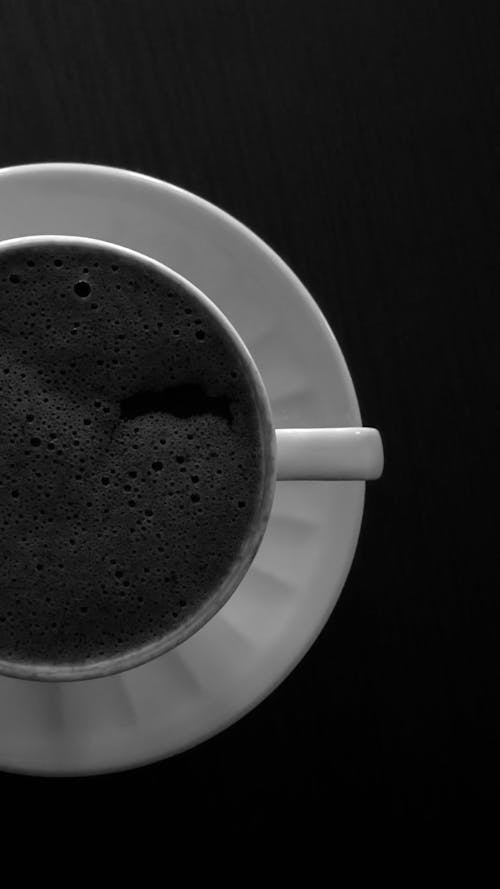 A black and white photo of a cup of coffee