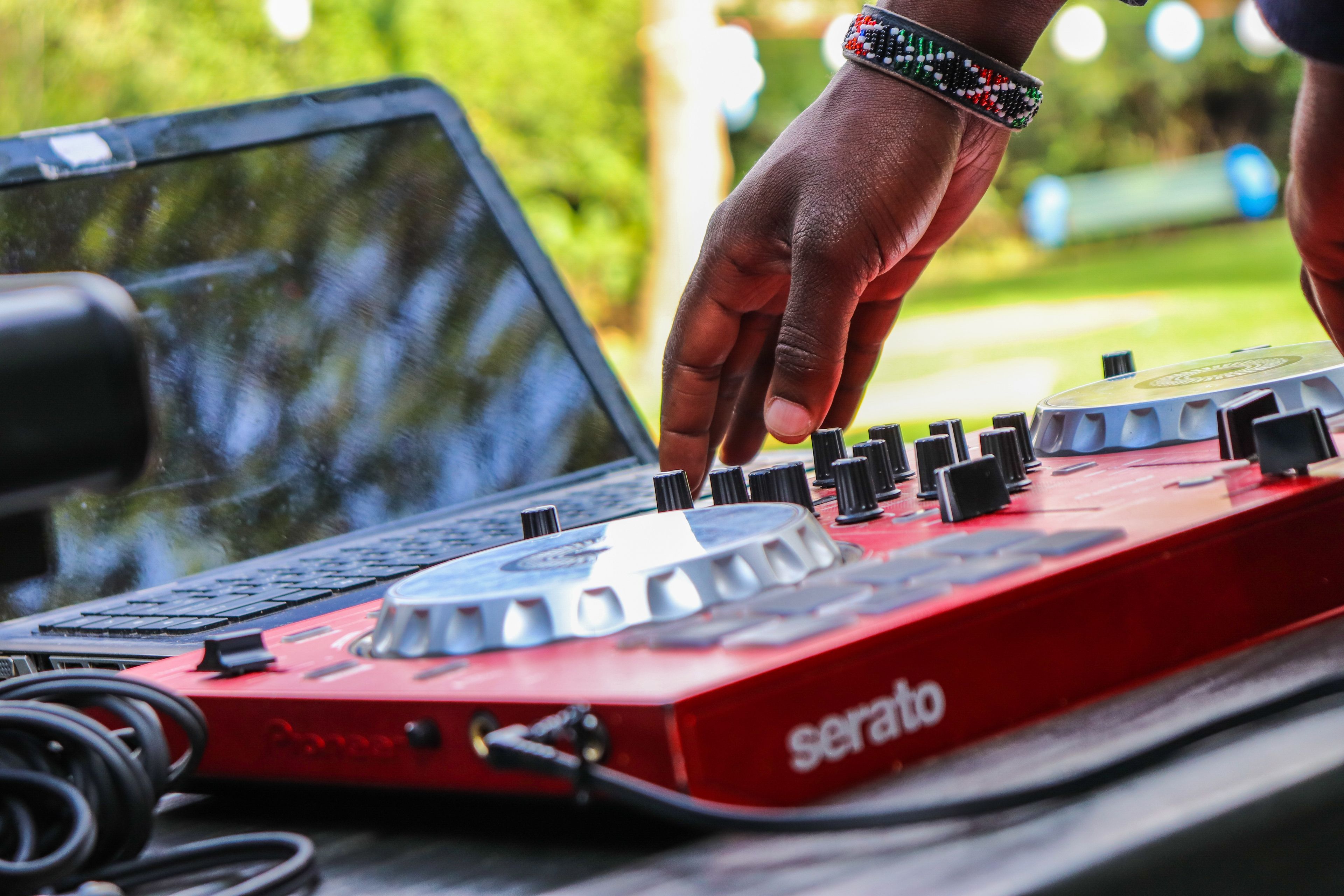 DJ adjusting a mixer outdoors in Nairobi, Kenya