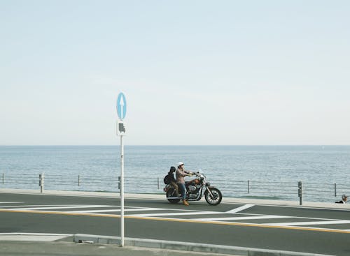 Man and Child Riding Motorcycle on Road