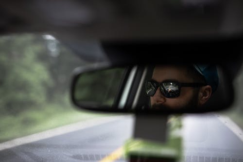 Reflection Of A Man On Rear View Mirror 