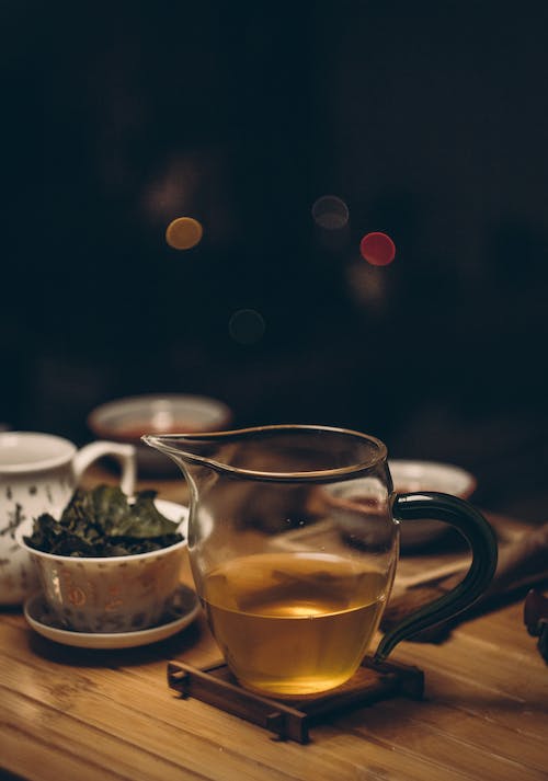 Clear Glass Cup on Brown Wooden Table