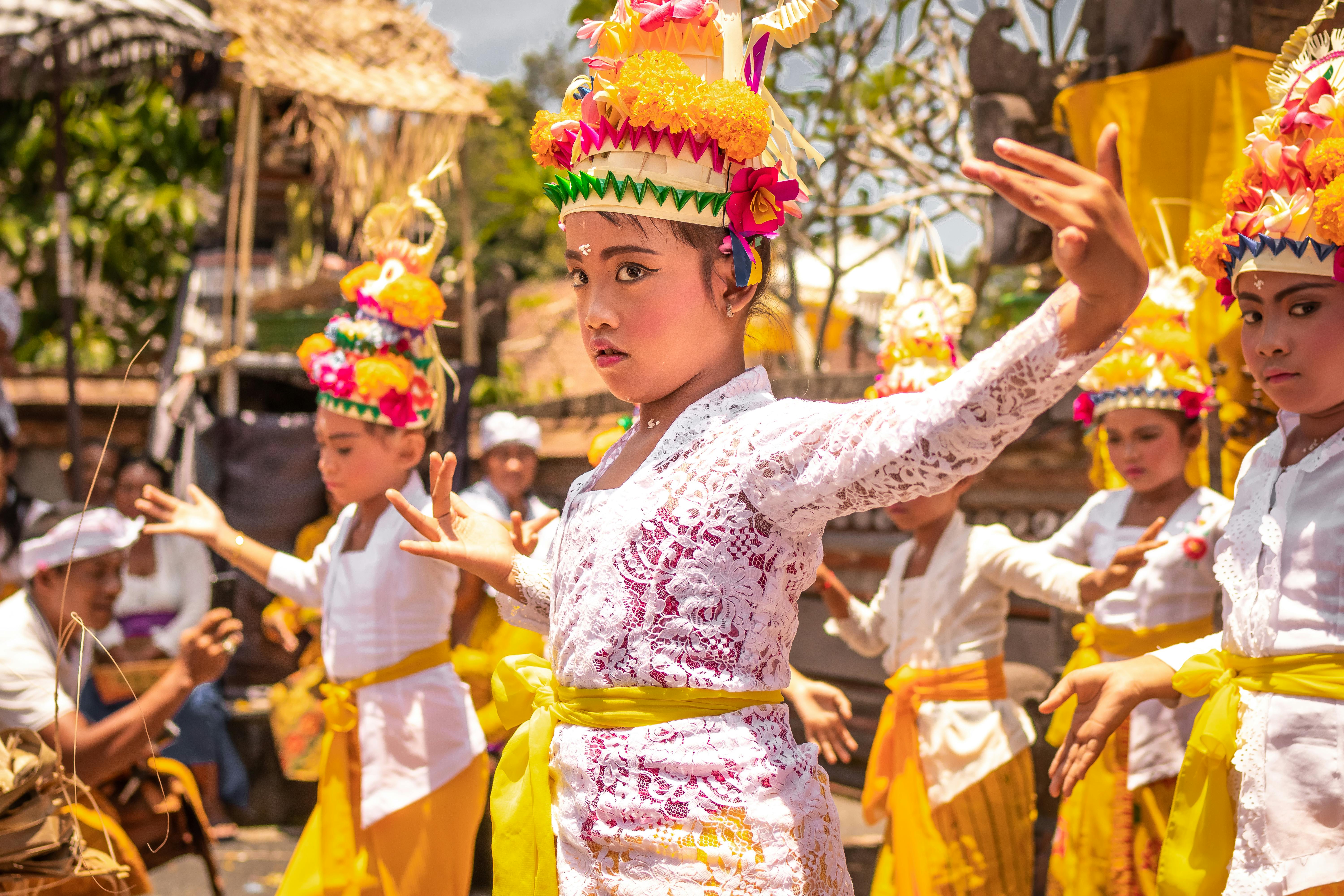Children Wearing Yellow and White Traditional Costumes and Dancing