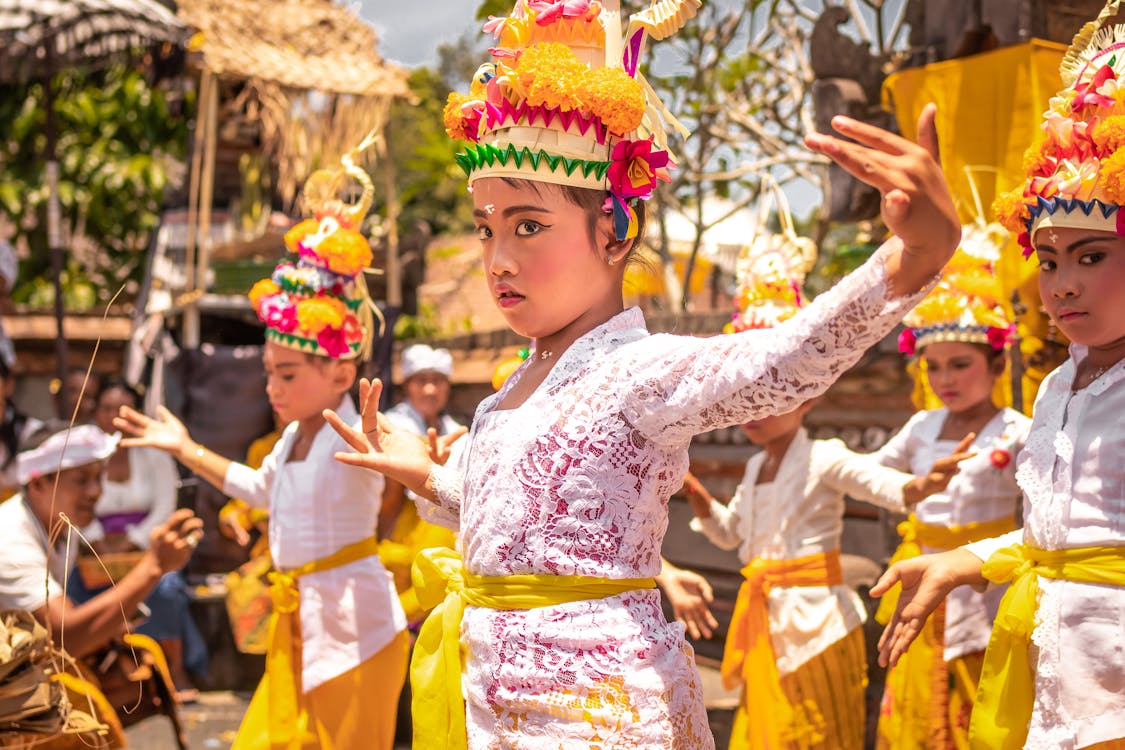 Children Wearing Yellow and White Traditional Costumes and Dancing