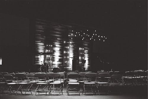 Grayscale Photography Of Chairs In An Auditorium